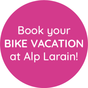 Pink circle with white text: BIKEURLAUB im Alp Larain buchen!.